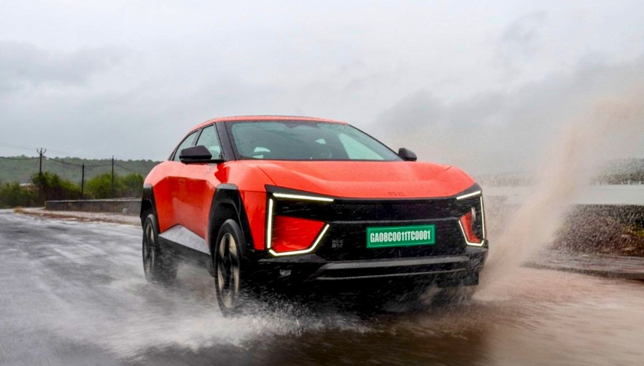Mahindra BE 6 electric SUV driving on wet road in rain