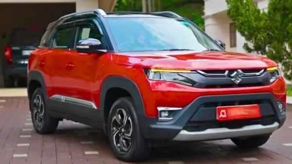 Red Maruti Brezza SUV parked outside with modern design
